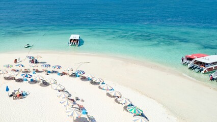 Fototapeta na wymiar Beach with colorful umbrellas and beach chairs, Phuket and Phi Phi Island, Thailand