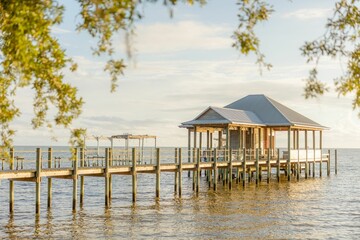 Scenic view of a picturesque lake with a peaceful pier and lush  in Fairhope, Alabama