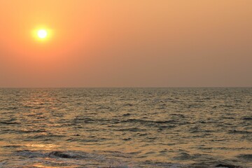 a kite boarder is enjoying some fun in the sunset