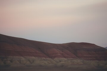 Fototapeta na wymiar Dusk over the Painted Hills, horizon in earthy tones.