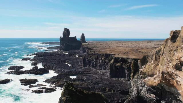 Londrangar Rock Formation, Snaefellsnes Peninsula, Iceland - Birds Soaring Above - Static Shot