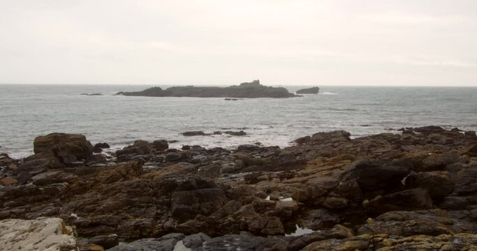 Low-level shot of St Clement's Isle with rock in foreground, Cornwall