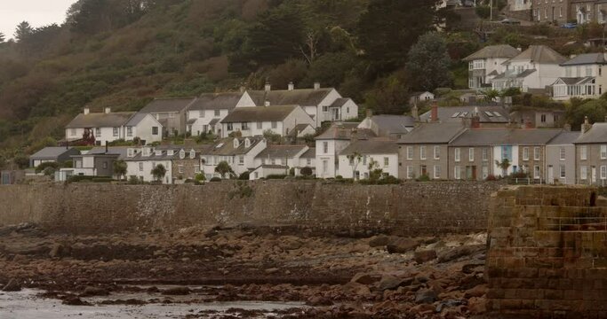 shot of mousehole Cornwall low tide looking past the harbour
