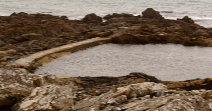 Low-level shot of Mousehole Rock Pool tidal swim pool, Cornwall