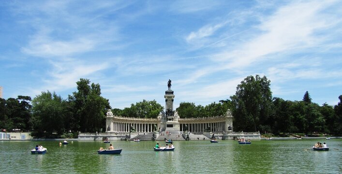 Scenic view of Retiro Park with boats floating on the tranquil lake. Madrid, Spain.
