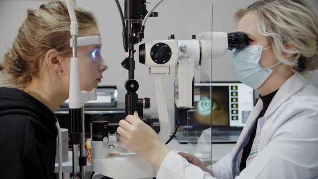 The ophthalmologist examines the patient's eye and then looks into the camera. Close up footage