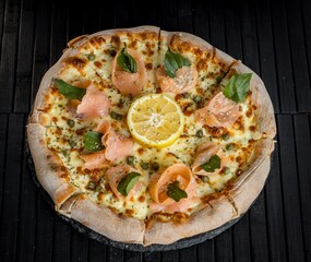 a pizza on a black grill lemon with cheese and garnish on it