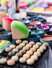 Closeup of colorful paintings for children's face painting with brushes and sponges