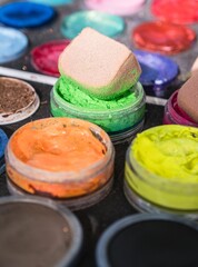 Closeup of colorful paintings for children's face painting with brushes and sponges