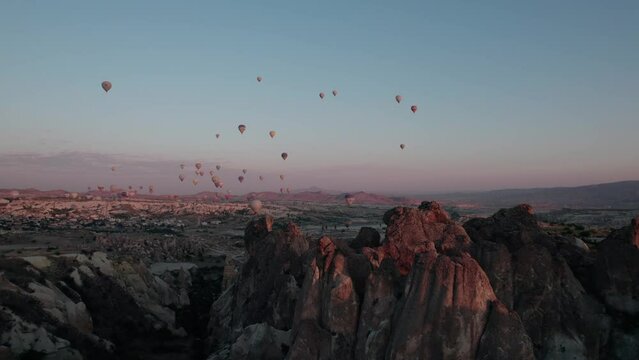 Balloons flying over Cappadocia during sunrise, aerial view, drone video 4K