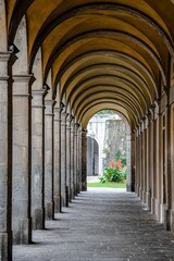 Majestic corridor featuring numerous grand arches and pillars crafted from stone