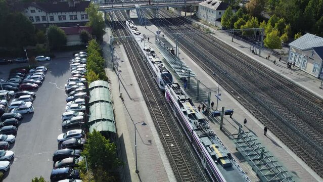 Railway Station in Kerava Finland, flock of pigeons flies past twice