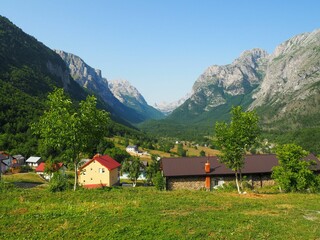 Scenic view of a rural mountain valley with picturesque houses.