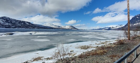 Snowy river, with snow-covered ground in the foreground