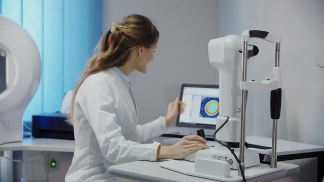 The ophthalmologist examines the patient's eye and then looks into the camera. Slow motion