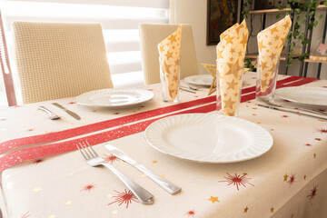 
Christmas table decorated with Christmas tablecloth and red ribbon