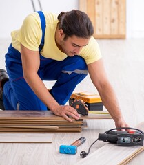 Young male contractor working indoors