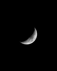 Obraz na płótnie Canvas Stunning crescent moon illuminating the night sky against a dark backdrop