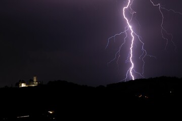 Scenic view of a lightning strike in hills at night