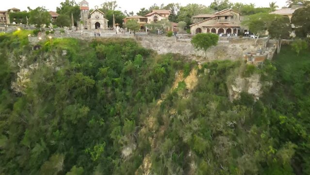 Aerial view of Altos de Chavon with its green areas and cloudy sky at sunset.