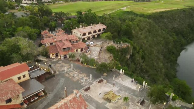 Aerial view of Altos de Chavon with its green areas and cloudy sky at sunset.