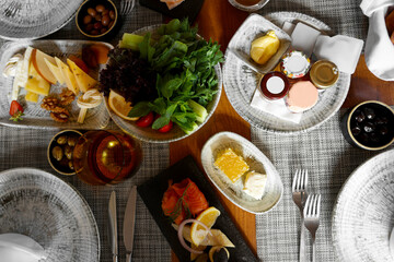 Different delicious food served on wooden table, flat lay