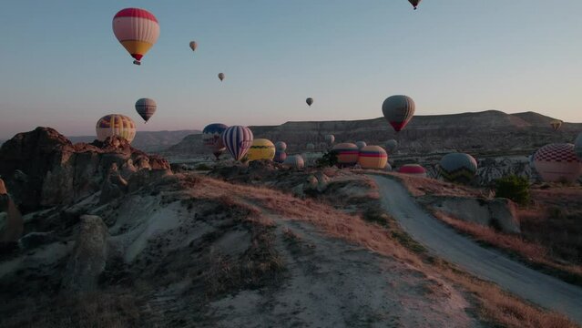Balloons flying over Cappadocia during sunrise, aerial view, drone video 4K