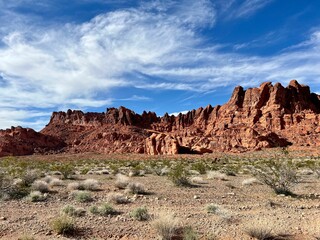 Majestic landscape of large red rocks against a cloudy blue sky