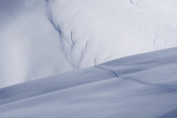 Fototapeta na wymiar Scenic view of a snow-covered mountain rising majestically from the surrounding snowy landscape