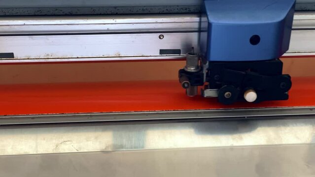 Cutting plotter close-up. The process of cutting a vinyl film