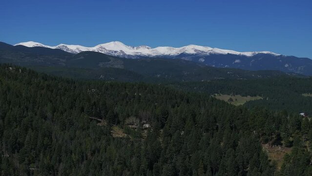 Cinematic aerial drone first snow on Mount Blue Sky Evans 14er peak early autumn fall beautiful blue bird clear morning sunrise day Colorado Rocky Mountains circle righty slowly movement