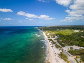 View of a tropical white sand beach surrounded by crystal clear water , North Coast of Cayman Brac