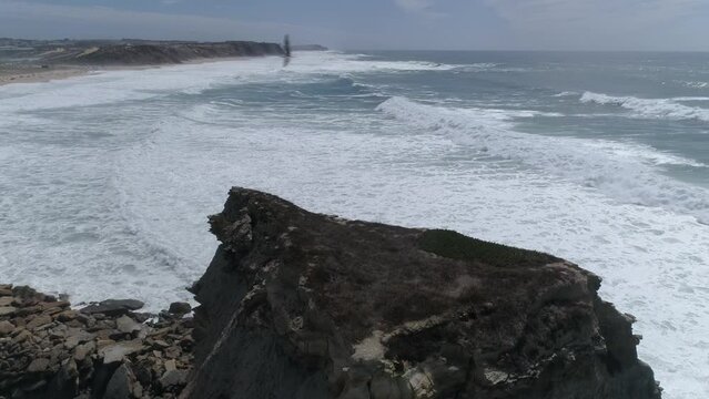 Large rock in the blue sea on a sunny day. Aerial view Rocky cliff in the ocean in  Portugal