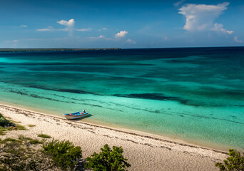 View from above showing the beach, sky and one boat
