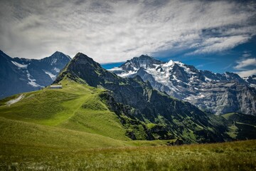 Fototapeta premium Landscape of the Mannlichen covered in the snow and grass in Switzerland