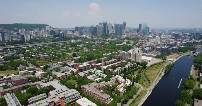 Aerial view flying along the Lachine Canal, tilting toward the skyline of Montreal