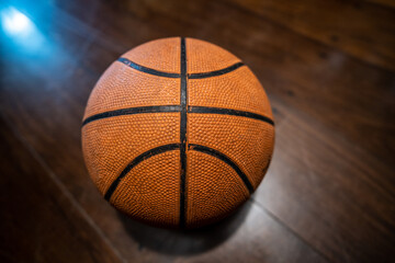 Classic basketball ball on wooden floor