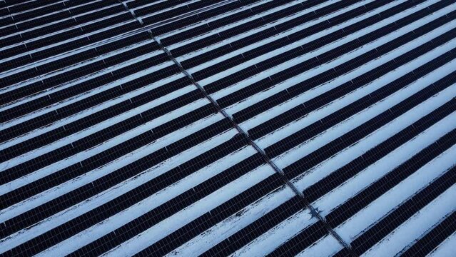 A snow-covered field with non-operational solar panels during a Canadian winter.