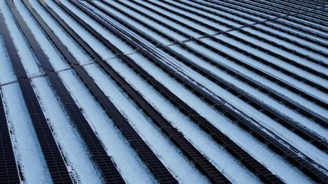 A large-scale solar panel power plant covered with snow in Canada.