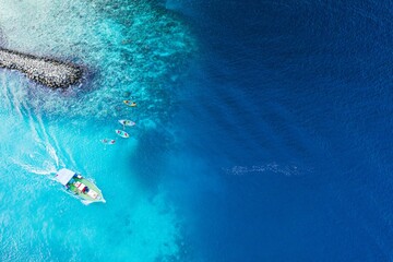 Aerial view of a  beautiful beach and crystal-clear blue ocean water  in the Maldives