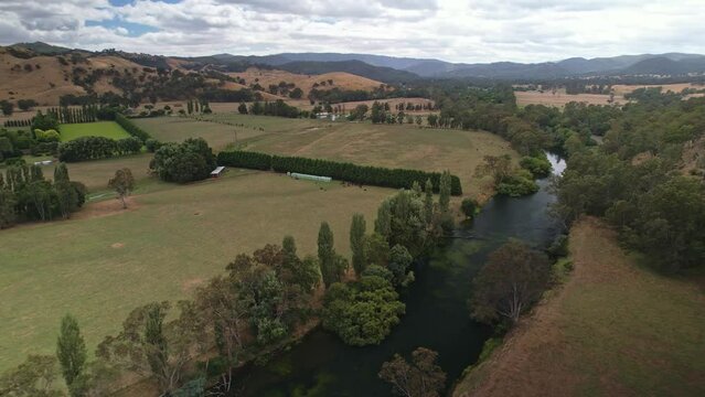 Reveal of the Goulburn River with paddocks and hills in the background near Eildon, Victoria, Australia