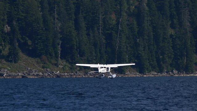 Seaplane Landing Over Blue Water Lake In British Columbia, Canada. Wide Shot