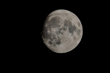 Celestial full moon illuminated in the dark night sky, with a bright white hue
