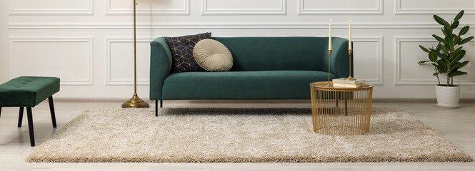 Stylish living room interior with soft beige carpet, side table and sofa. Banner design - obrazy, fototapety, plakaty