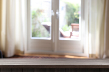 Empty wooden table in room, blurred interior. Space for design