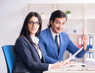 Two employees working in the office