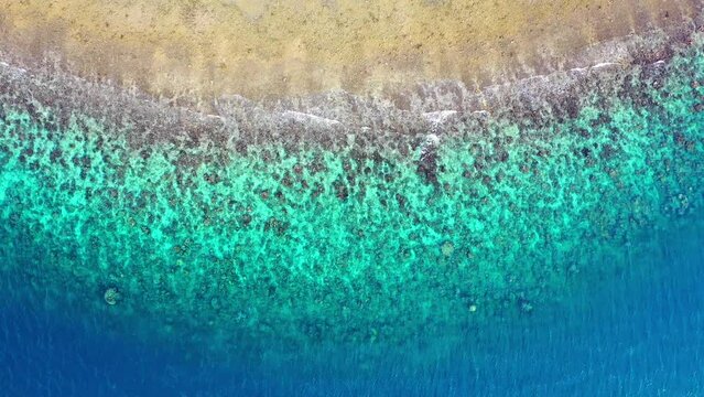 top down shot of blue and green transparent water at the beach in the Mediterranean.