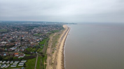 Picturesque seaside landscape featuring a long stretch of beach, overlooks a tranquil ocean