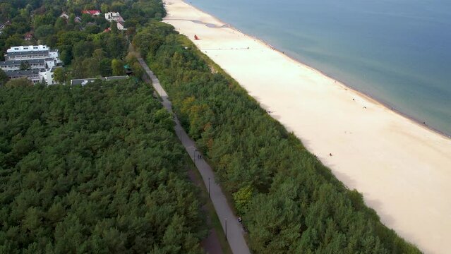 Aerial panoramic overview of bike and walking path parallel to beach of Gdansk Jelitkowo Poland