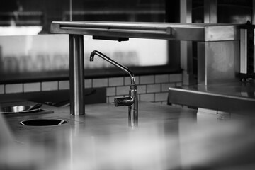 Gray scale shot of a stainless steel countertop kitchen sink